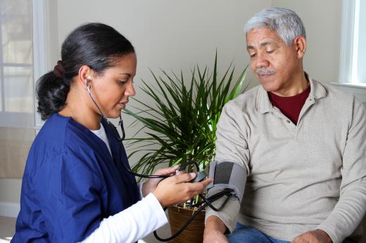 A medical professional checks a man's blood pressure.