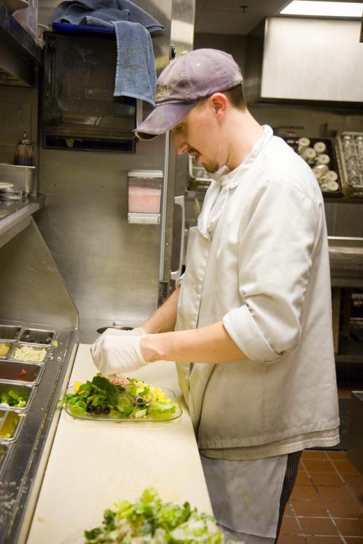 A chef wearing gloves for food safety.