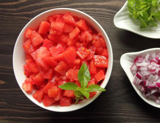 Chopped tomatoes can be layered on the crust of a tomato pie.