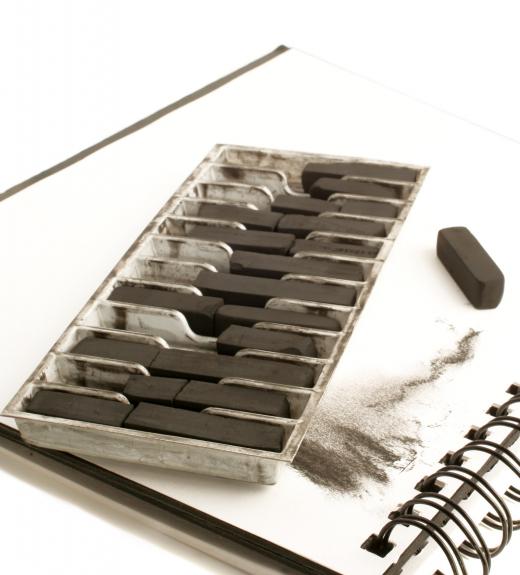 An art instructor may have a variety of art supplies available for use, including compressed charcoal sticks.