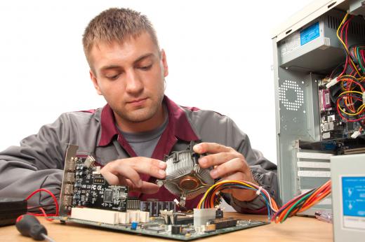 A computer technician with an associate's degree in electronics working on a computer.