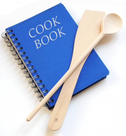 A cookbook and utensils.