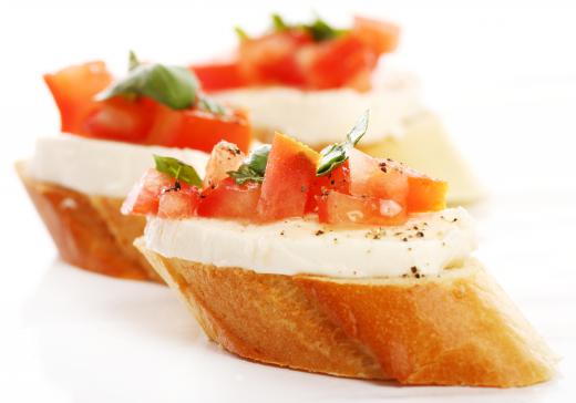 Crostini with mozzarella cheese, chopped tomato and basil, a vegetarian appetizer.