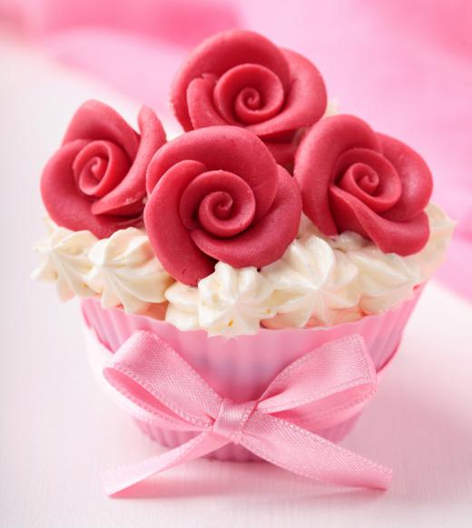 A cupcake decorated with marzipan, a type of almond paste.