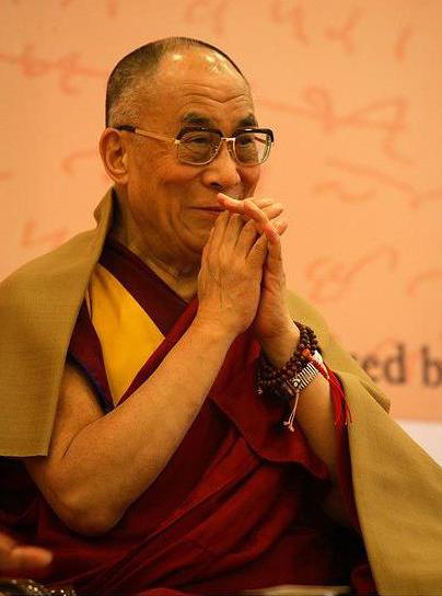 The 14th Dalai Lama, wearing mala beads on his wrist.