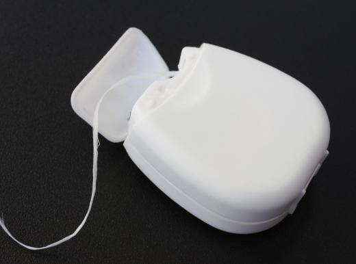 A dental floss threader is used to floss around braces.