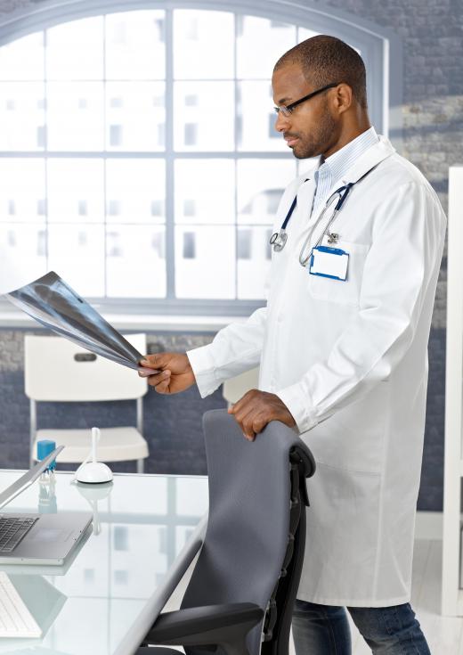 A radiologist examines a patient X-rays.