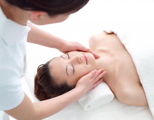 An esthetician giving a facial.