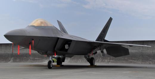 Mechanics who work on fighter aircraft's such as the F-22 Raptor, must first remove an engine that needs servicing from within the aircraft's fuselage.