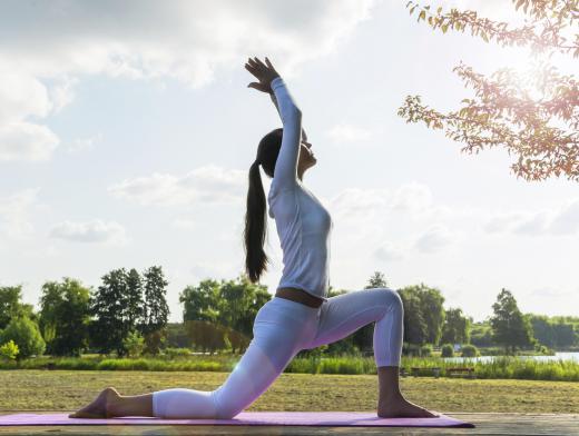 A yoga towel is designed to fit on top of a yoga mat.