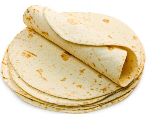 Flour tortillas are most commonly used to make seven layer burritos.