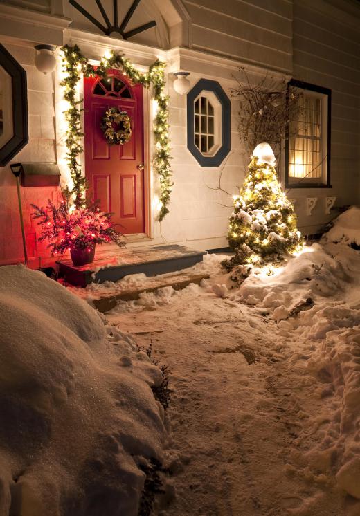 A Christmas wreath and lights add a lovely touch to a small porch.