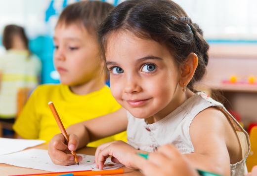 A kindergarten teacher engages young students.