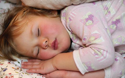 The bedwetting alarm setup includes a moisture-sensitive sensor placed on a sleeping child's underwear, which awakens the child to visit the bathroom.