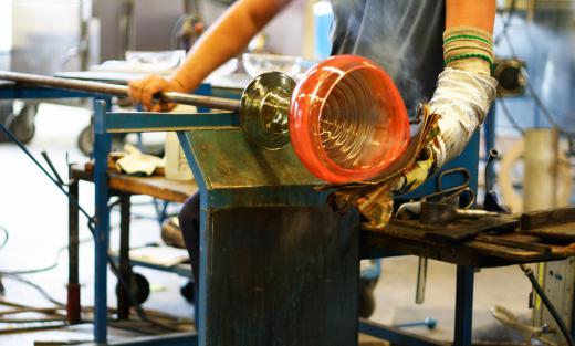 Glass blowers use blowpipes to inflate and shape molten glass into items such as vases, bottles or cups.