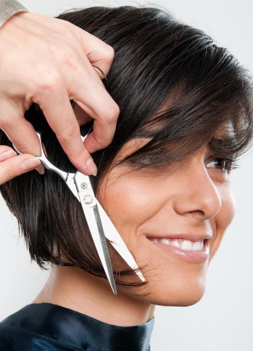 A hairstylist cutting a short bob. An experienced stylist should be able to match a haircut to her client's face shape and personality.