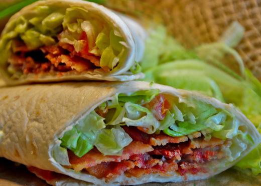 Avocado can be added to a traditional BLT wrap sandwich made with bacon, lettuce, and tomato.