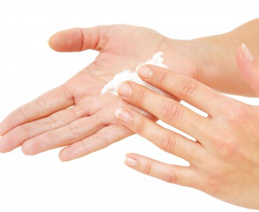 A woman using jojoba hand lotion.