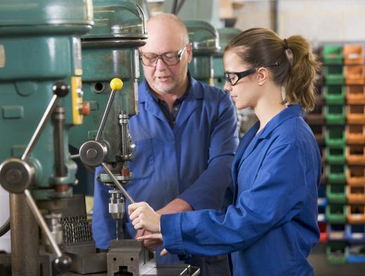 A tender performs regular tasks to maintain the working order of machinery.