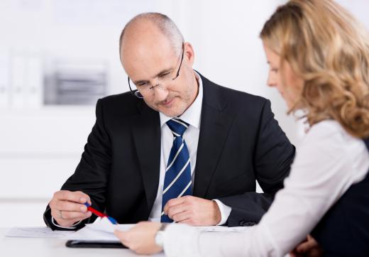 One part of loan processing involves reviewing financial paperwork and employment verification.