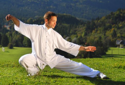 A tai chi instructor teaches students about the positions, postures, moves, forms, and poses used in tai chi.