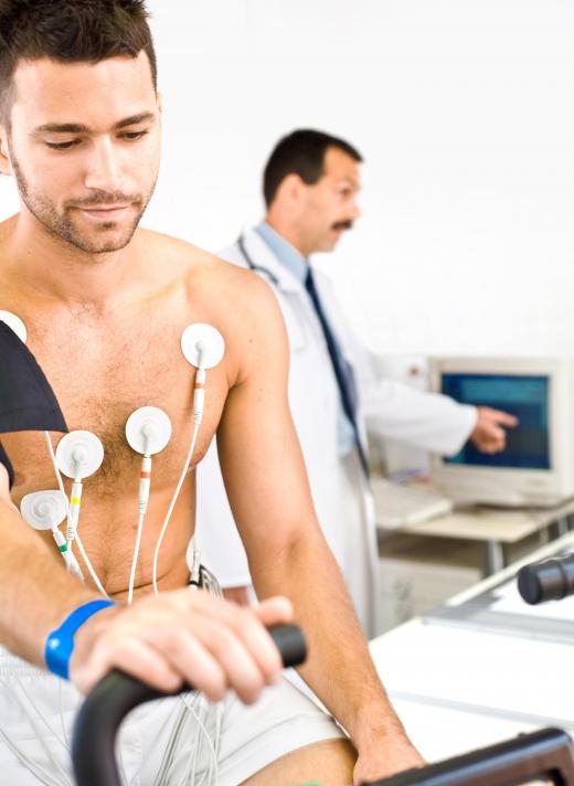 A man getting an EKG, a type of heart screening.