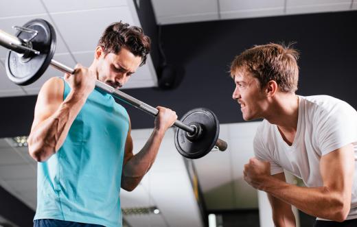 When curling a barbell, individuals should take a deep breath before the curl and exhale as the barbell is moved toward the body.