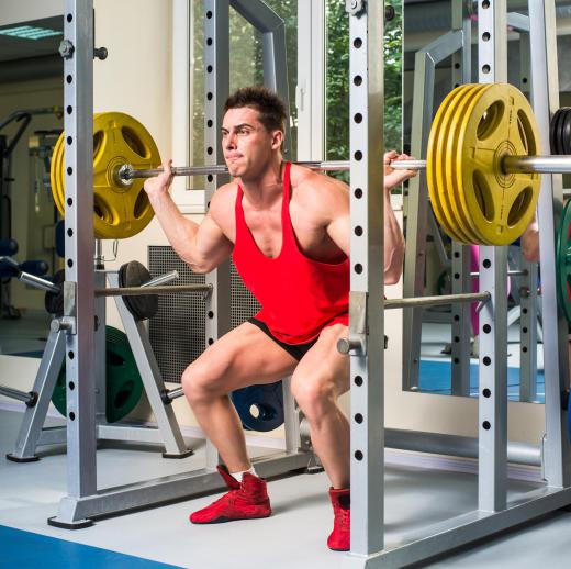 Performing squats, especially with heavy weights, can be performed more safely with the assistance of a power rack or cage.