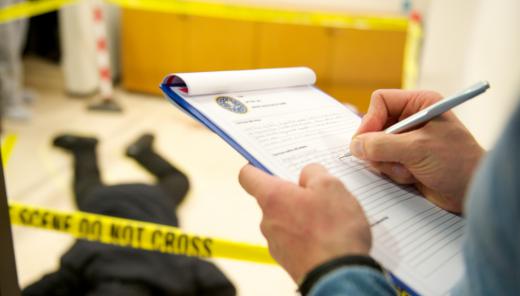 A latent print examiner looks for fingerprints at a crime scene.