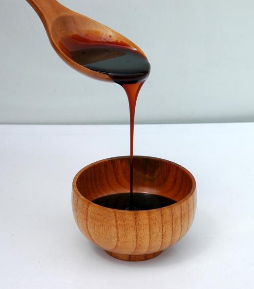 Molasses being poured from a spoon.