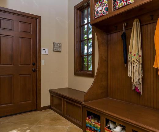 A mud room bench provides a place to sit and remove shoes and boots.