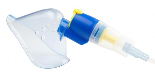 A hand-held nebulizer may deliver medication via a mask.