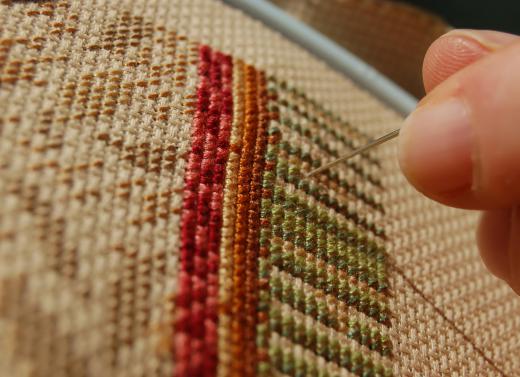 Needlepoint chair seats may be used to decorate a vintage style bathroom.