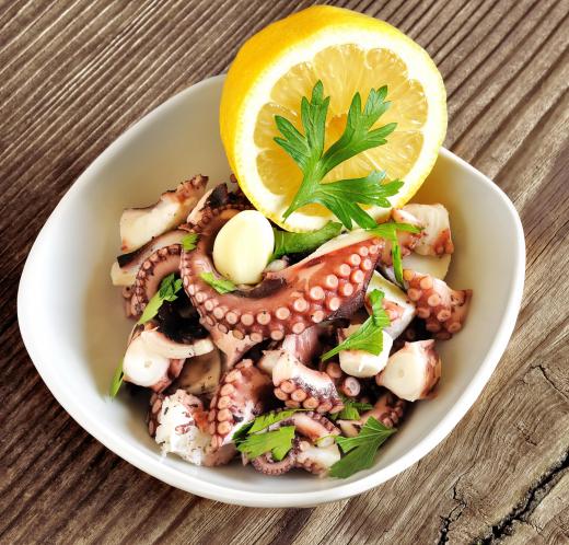 An octopus dish garnered with lemon.