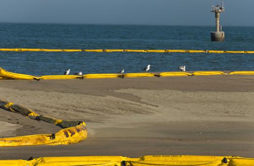 Oil booms being used to contain an oil spill in the ocean.