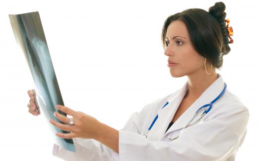 A radiology supervisor looking at an X-ray.