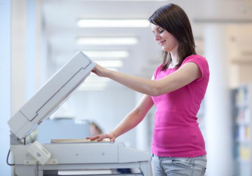 A photocopier is commonly shared in cubicle work spaces.