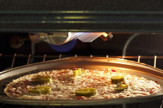 A pizza in a countertop pizza oven.