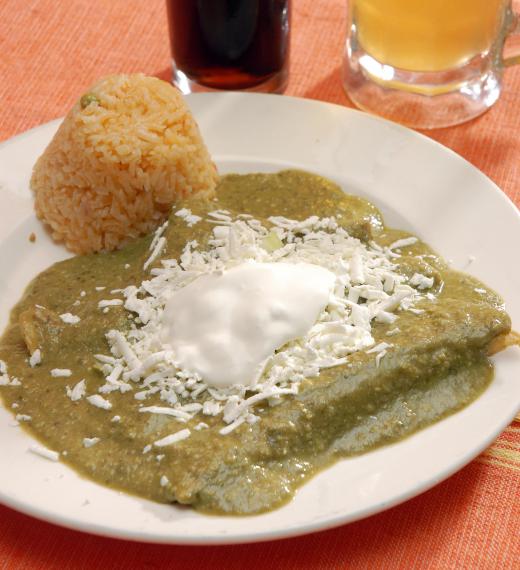 Enchiladas verdes served with Mexican rice.