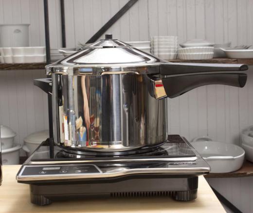 A pressure cooker on an induction burner.