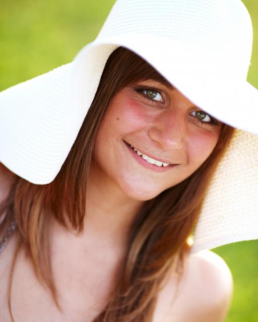 Wearing a hat while out in the sun can help protect your face.