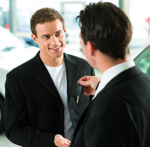 A car dealer selling a car.