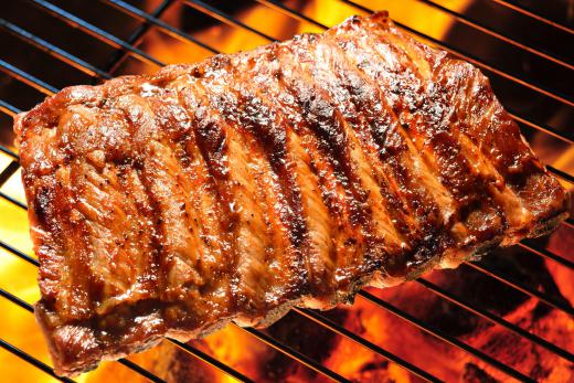 Many people cook short ribs on a grill.