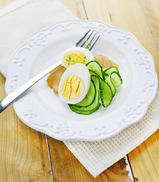 A garnish enhances the decorative aspect of a dish, like cucumber spirals in a salad.