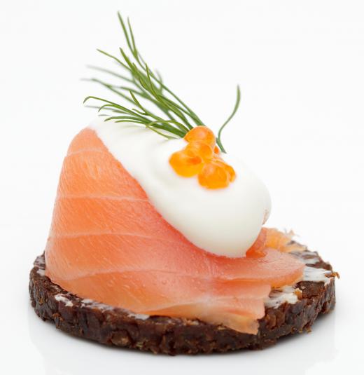 Smoked salmon canapés with crème fraîche, caviar and dill.