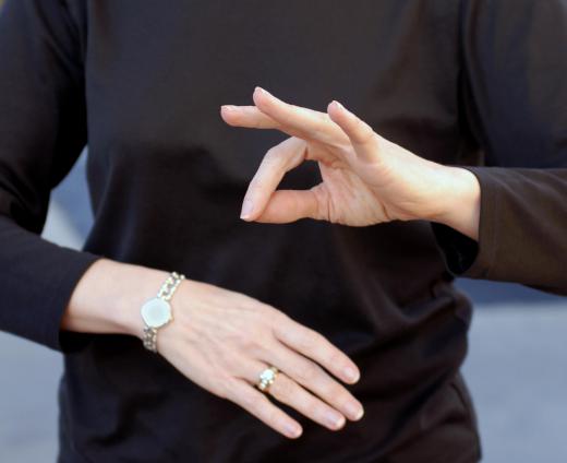 A sign language interpreter provides spoken word translations for the deaf and hearing impaired.