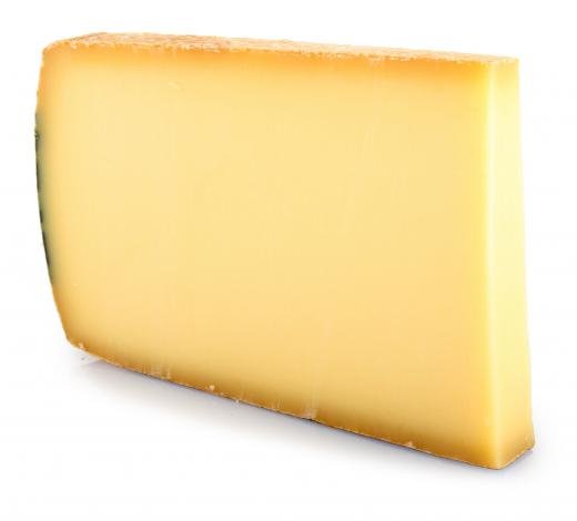 Thick slice of Gruyere cheese, which is commonly used in quiche tarts.