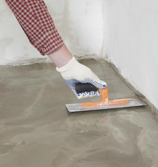 Trowels are used to smooth the surface of the newly-poured countertop.