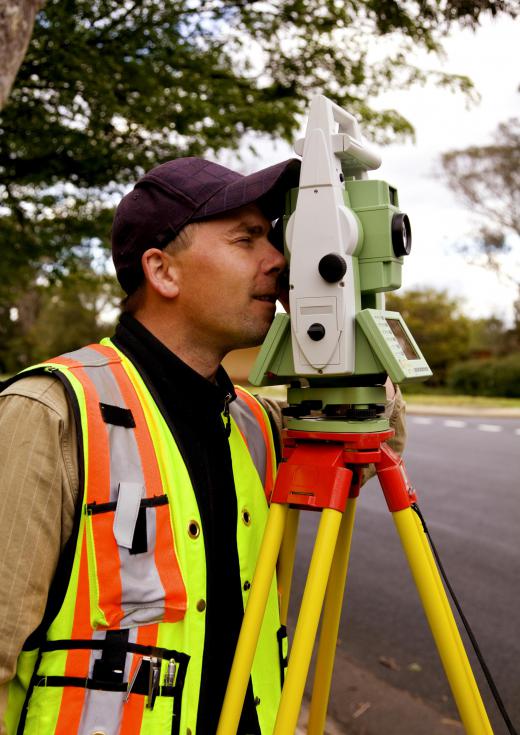 A surveyor uses a theodolite to survey property.