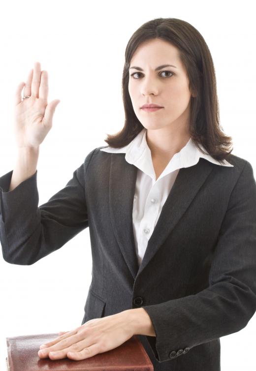 A witness takes an oath to tell the truth before giving testimony.